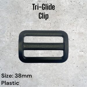 Black plastic tri-glide clip, 38mm. Three parallel bars inside a rectangular frame.