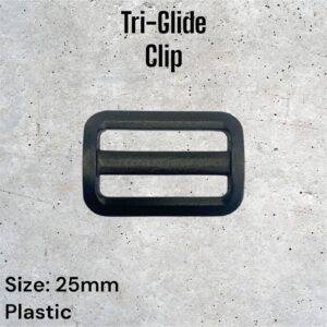 Black plastic Tri-Glide clip, 25mm. Three parallel bars. Suitable for straps or belts.