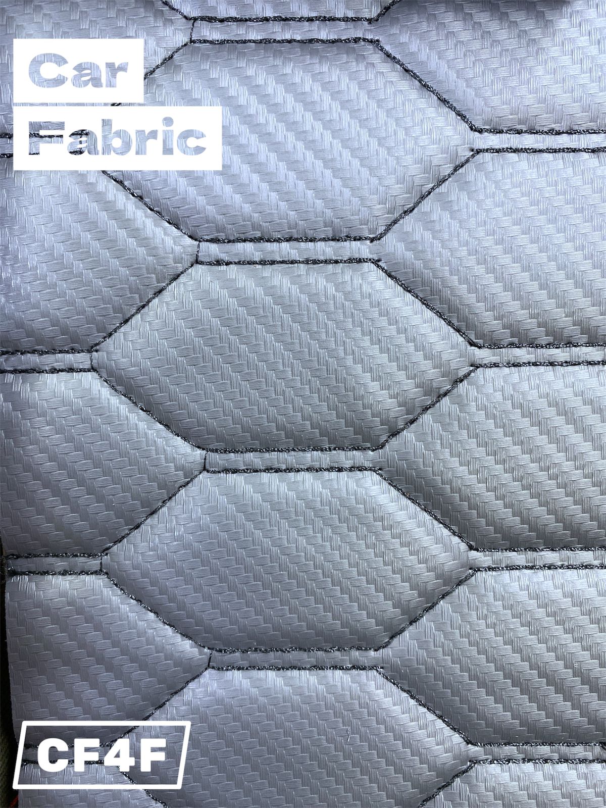 Silver patterned fabric with a subtle woven texture and hexagonal quilting. Suitable for automotive upholstery.