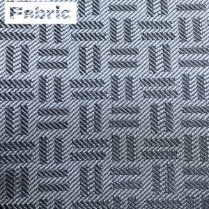 Close-up of gray car fabric with a subtle geometric pattern. The fabric has a woven texture with varying shades of gray 